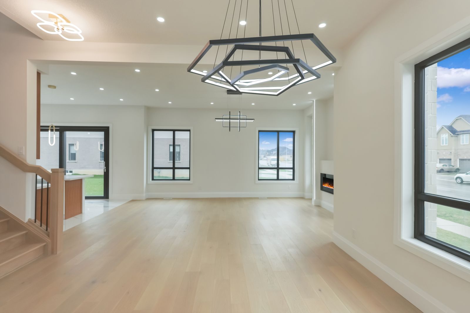 Wide-plank hardwood in an open-plan great room in a completed Carnaby home