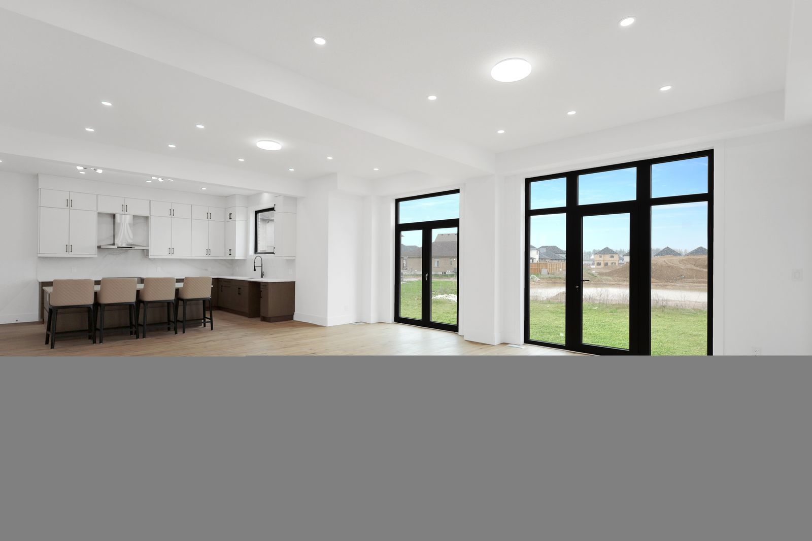 Hardwood meeting walls of glass in a completed Carnaby home