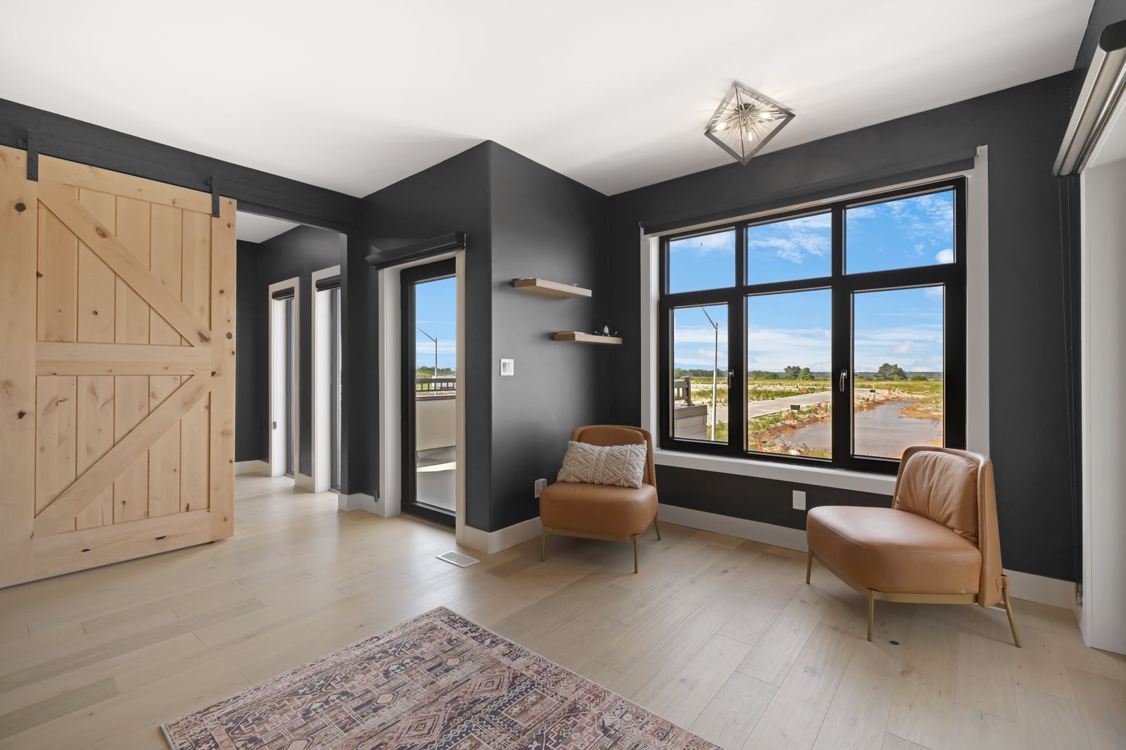 Loft lounge with barn door in a completed Carnaby home